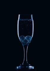 A glass for champagne with glass balls and bubbles in blue style