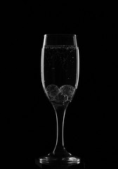 A glass for champagne with glass balls and bubbles in monochrome