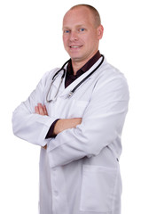 Medical doctor in white lab coat and stethoscope smiles and crosses his arms over his chest against a white background