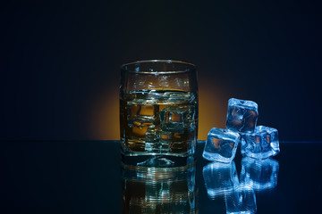 Ice and brandy or cognac in glass with 