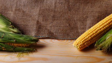 Grains of ripe corn on background. Rustic, wooden table