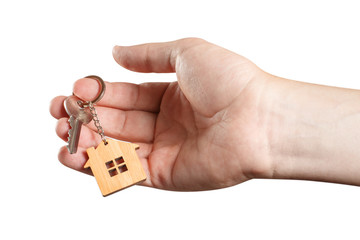 Hand of a real estate agent holding a house key, isolated on white background