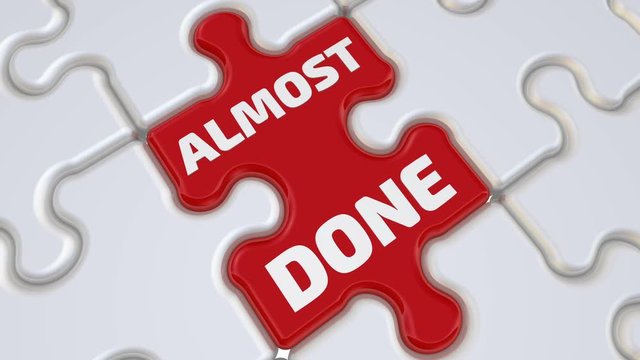 Almost done. The inscription on the missing element of the puzzle. Folding white puzzles elements and one red with text ALMOST DONE. Footage video