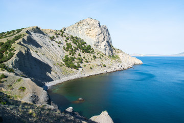 Fototapeta na wymiar Beautiful rock off the coast of the sea. Turquoise water, blue sky, incredible landscape.