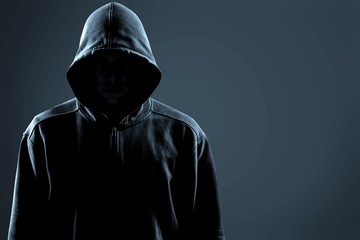 Thief in black clothes on grey background