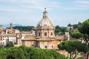 Fototapeta na wymiar Aerial scenic view of Colosseum, Roman Forum in Rome and church of Santi Luca e Martina, Italy