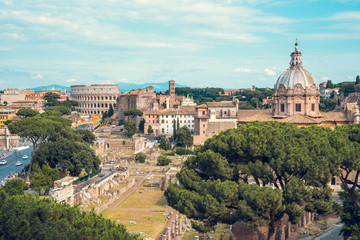 Fototapeta na wymiar Aerial scenic view of Colosseum, Roman Forum in Rome and church of Santi Luca e Martina, Italy