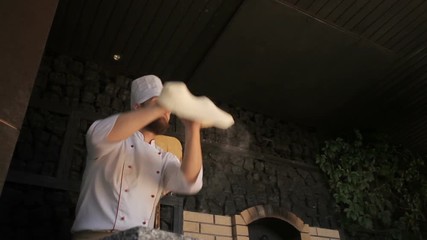 Chef tossing pizza dough