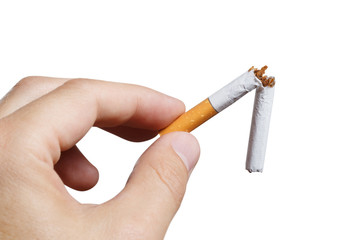 Close-up of fingers holding a cigarette broken in half, isolated on white background