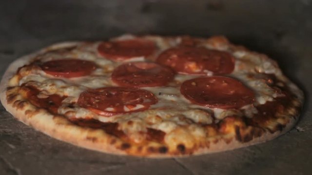 Italian pizza is cooked in a wood-fired oven