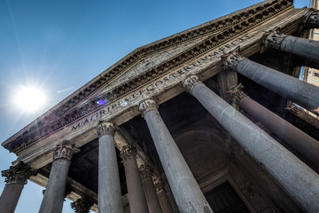 Naklejka premium Looking up into bright sunlight at the entrance to the Pantheon in Rome