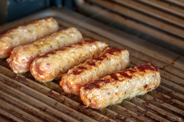 Cevapcici baked on the grill. Small sausages from minced meat, a very popular dish in the Balkan countries.