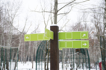 Pointers on vintage wooden poles. Winter. Mock up