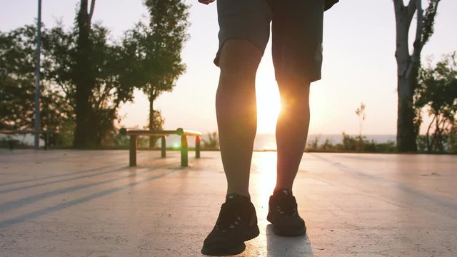 Fit handsome middle aged man walking on sports ground with sea background, close up shot