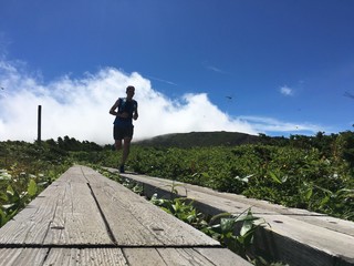 Male trail runner on mountain top boardwalk