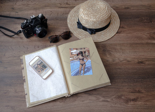 photo album with camera, phone, straw hat and sunglasses