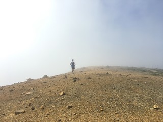 Runner on rocky mountain top