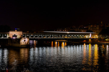 Metro crossing Passy (Bir-Hakeim) bridge at night - Paris, France