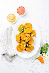 Healthy vegetarian nuggets with carrots, cauliflower and spinach. Vegetable nuggets. Vegan food. Top view, white background