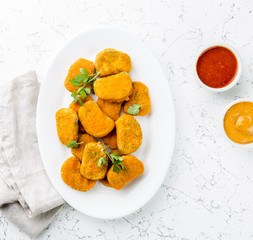 Healthy vegetarian nuggets with carrots, cauliflower and spinach. Vegetable nuggets. Vegan food. Top view, white background