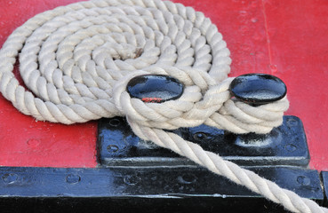 Ship bollard with rope around it. 