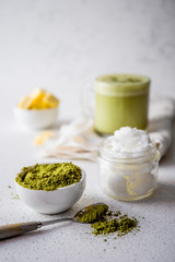 BULLETPROOF MATCHA. Ketogenic keto diet hot drink. Tea matcha blended with coconut oil and butter. Cup of bulletproof matcha and ingredients on white background