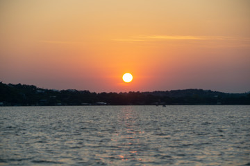 Naklejka premium Sunset on a Hill Country Texas Lake from the water