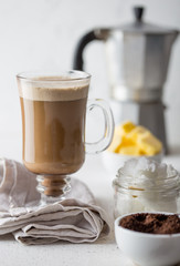 BULLETPROOF COFFEE. Ketogenic keto diet coffe blended with coconut oil and butter. Cup of bulletproof coffee and ingredients on white background