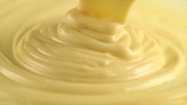 White chocolate. Pouring melted liquid premium white chocolate. Confectionery. Slow motion. 3840X2160 4K UHD video footage