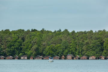 Old Boathouses on a Lake with Trees of a Forest