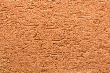 Yellow ochre painted stucco wall. Background texture