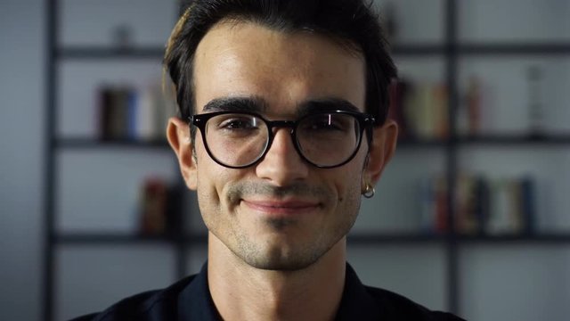 Happy Handsome Gay Man Sitting on the Couch, Relaxing at Home.