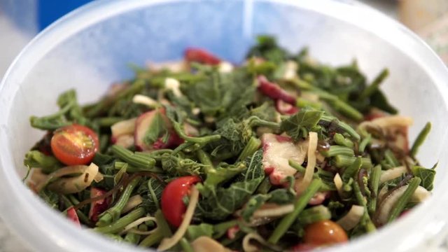 Chayote or Pipinola salad is a popular tasty green, exotic, appetizer salad found in Hawaii. It is prepared with a mixture of the chayote shoot, tomatoes, onions, cooked octopus, lemon, and soy sauce.