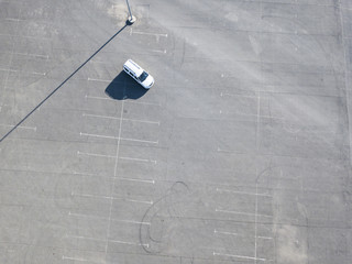 top aerial abstract view of blue car running on asphalt with parking lots isolated copy space design © Mihail