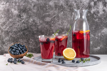Fresh blueberry summer mojito cocktail. Blueberry lemonade or sangria on kitchen countertop.