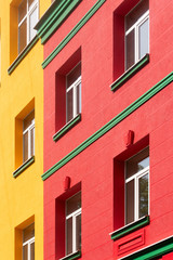 Fototapeta na wymiar yellow-red building with green cornice, close-up shot, building element