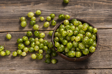 fresh homemade gooseberries in a plate on a table in the garden