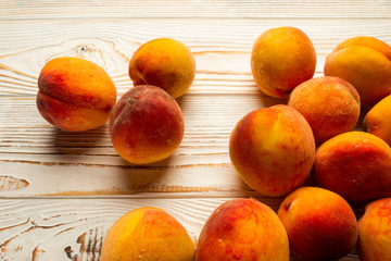 Naklejka na ściany i meble fresh ripe peaches close-up on a light wooden table