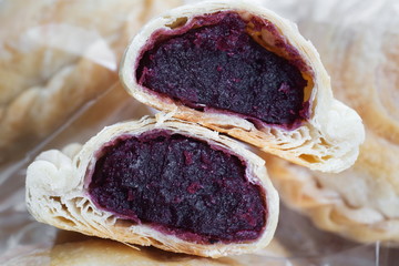 Bakery homemade,Curry puff with stuffed purple sweet potato on wooden desk.