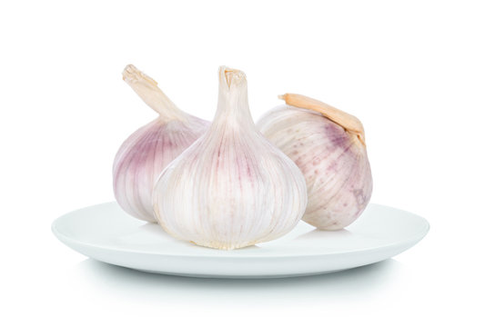 garlic in white plate on white background