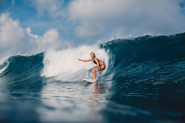 Surfer woman at surfboard on ocean wave. Attractive surf girl on surfboard - obrazy, fototapety, plakaty