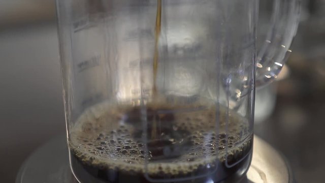 Slow drip coffee being poured.