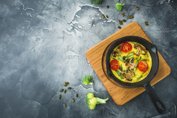 Healthy food of omelet in frying pan and pumpkin seeds. Flat lay, top view with copy space