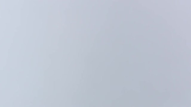 Man and woman fist bumping against white screen.