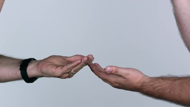 Two men playing rock paper scissors as one cheats and still looses the game.