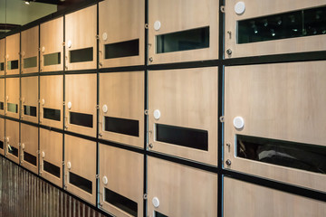 Wall of wooden postal mailboxes and lockers Communication throwback concept.