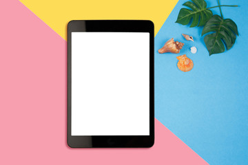 Digital tablet with blank screen on pastel color background, flat lay photo