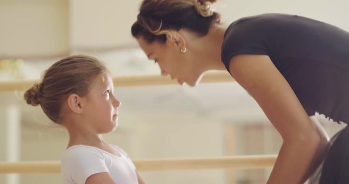 A teacher of classical dance teaches some steps to his young student who wants to learn how to dance. Concept of: ambition, education, teaching and love for the dance
