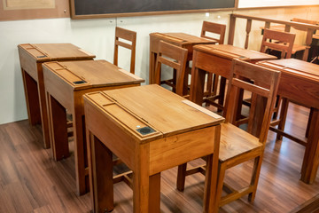 Wooden talble and chair with black speaker in vintage retro design style on wooden floor.