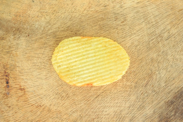 crispy potato chips junk food unhealthy food on wooden